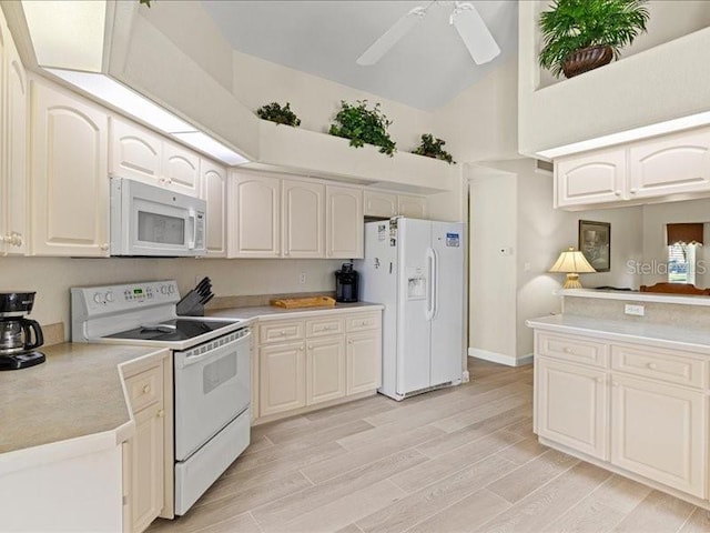 23 Pine Valley Ct, Rotonda West, FL 33947 - kitchen with white appliances, high vaulted ceiling, light countertops, light wood finished floors, and a ceiling fan