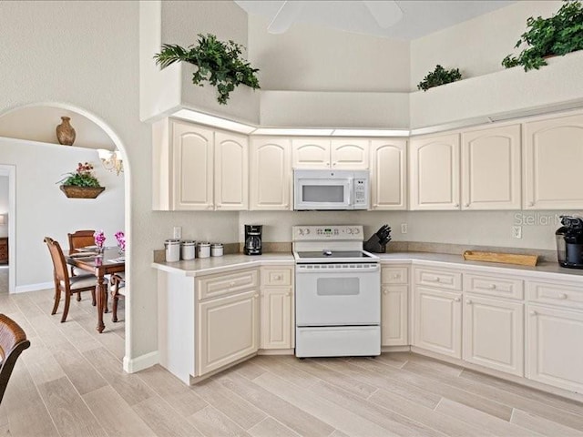 23 Pine Valley Ct, Rotonda West, FL 33947 - kitchen featuring white appliances, a high ceiling, light wood-style floors, and light countertops