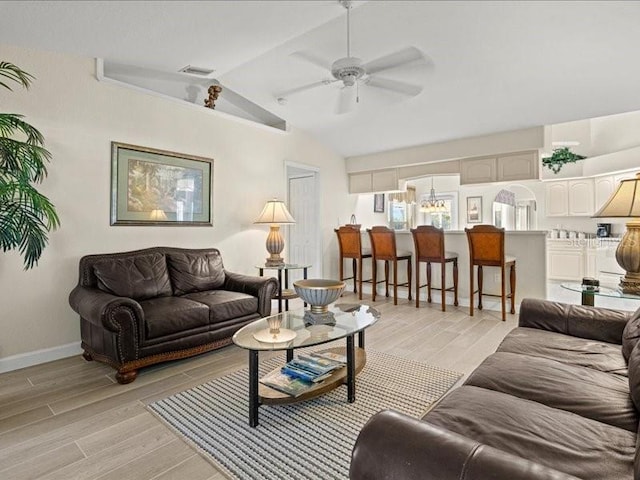 23 Pine Valley Ct, Rotonda West, FL 33947 - living room with a ceiling fan, lofted ceiling, and light wood finished floors