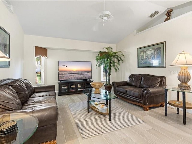 23 Pine Valley Ct, Rotonda West, FL 33947 - living room with vaulted ceiling, light wood finished floors, and ceiling fan