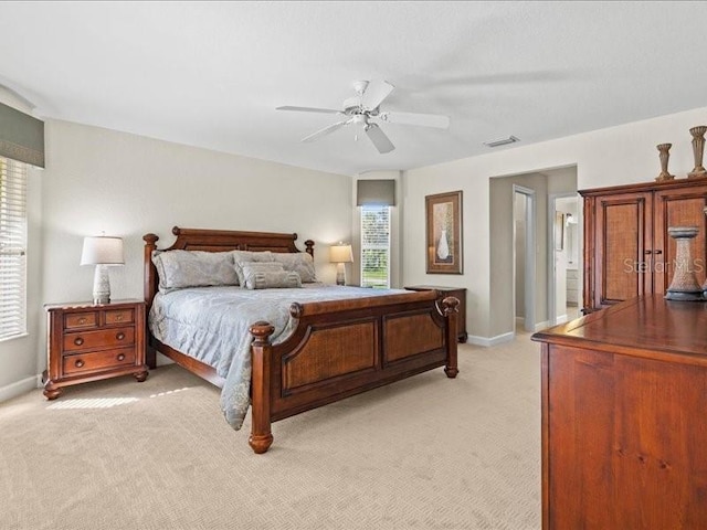 23 Pine Valley Ct, Rotonda West, FL 33947 - bedroom with multiple windows, light carpet, and a ceiling fan