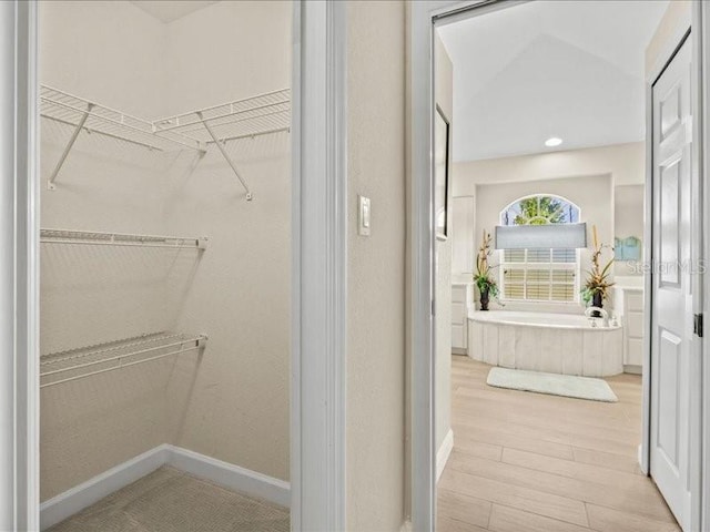 23 Pine Valley Ct, Rotonda West, FL 33947 - walk in closet featuring wood finished floors