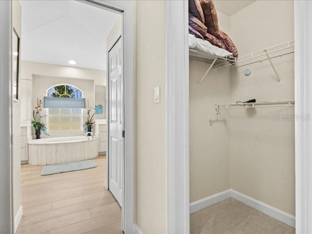 23 Pine Valley Ct, Rotonda West, FL 33947 - walk in closet with wood finished floors