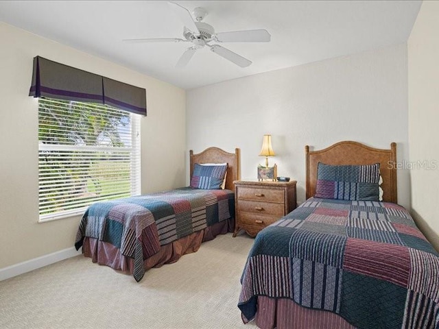 23 Pine Valley Ct, Rotonda West, FL 33947 - bedroom with light colored carpet and ceiling fan