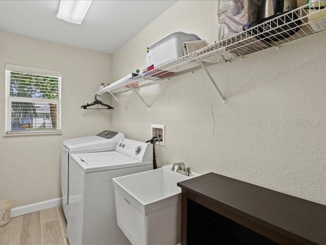 23 Pine Valley Ct, Rotonda West, FL 33947 - laundry area featuring washing machine and clothes dryer and light wood-style flooring