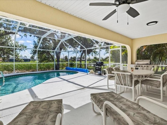 23 Pine Valley Ct, Rotonda West, FL 33947 - swimming pool featuring a patio area, area for grilling, a ceiling fan, a lanai, and outdoor dining area