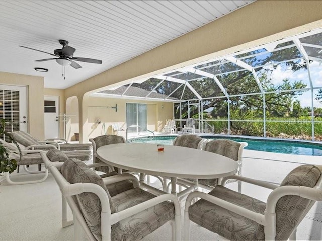 23 Pine Valley Ct, Rotonda West, FL 33947 - view of patio / terrace featuring outdoor dining space, a ceiling fan, an outdoor pool, and a lanai