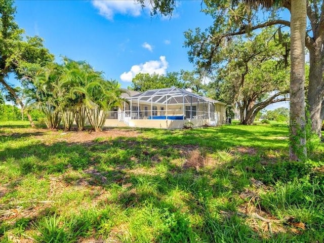 23 Pine Valley Ct, Rotonda West, FL 33947 - rear view of property featuring a yard and a lanai