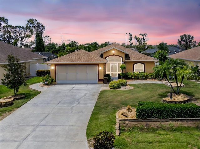 127 Jennifer Dr, Rotonda West, FL 33947 - single story home featuring stucco siding, driveway, a garage, and a lawn