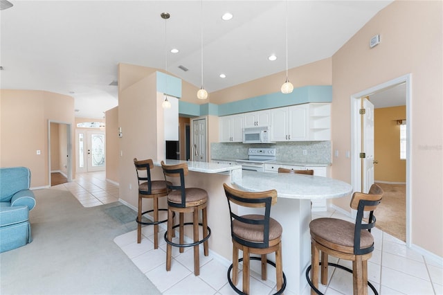 127 Jennifer Dr, Rotonda West, FL 33947 - kitchen featuring white appliances, light carpet, a peninsula, tasteful backsplash, and recessed lighting