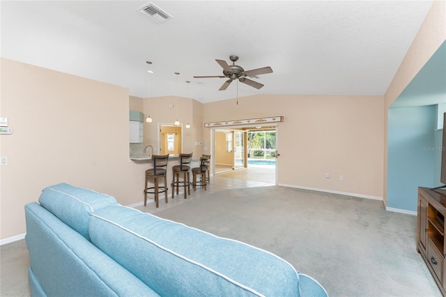 127 Jennifer Dr, Rotonda West, FL 33947 - living room with light colored carpet, a ceiling fan, and lofted ceiling