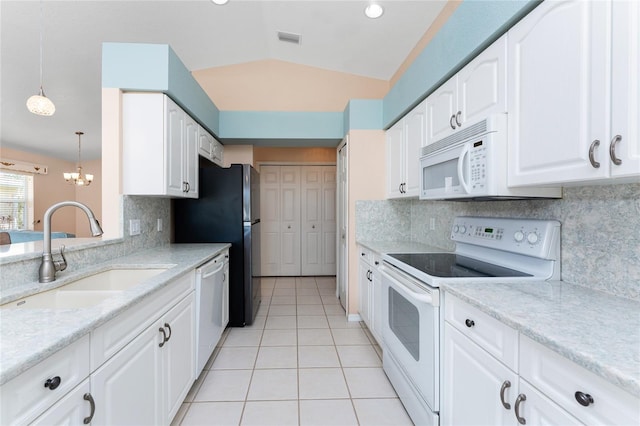 127 Jennifer Dr, Rotonda West, FL 33947 - kitchen featuring white appliances, light tile patterned flooring, white cabinetry, lofted ceiling, and tasteful backsplash