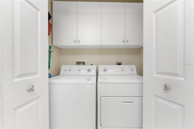 127 Jennifer Dr, Rotonda West, FL 33947 - laundry room featuring washing machine and clothes dryer and cabinet space