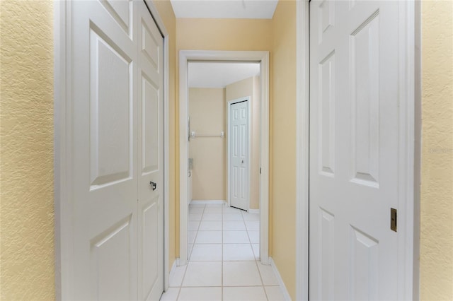 127 Jennifer Dr, Rotonda West, FL 33947 - corridor with light tile patterned floors and a textured wall
