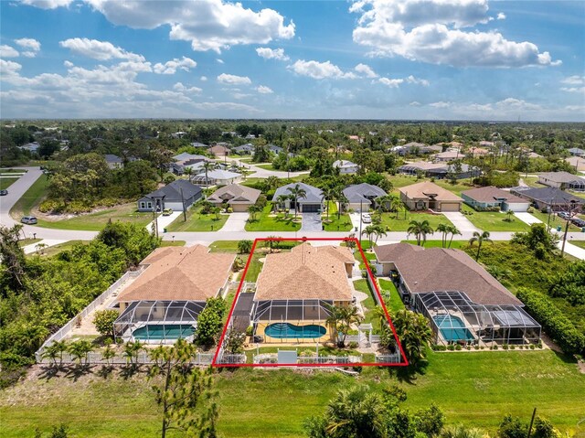 127 Jennifer Dr, Rotonda West, FL 33947 - aerial perspective of suburban area featuring a pool and property parcel outlined