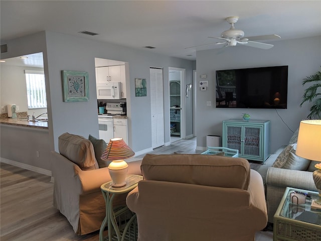 2373 N Beach Rd Unit 1C, Englewood, FL 34223 - living room featuring light wood-style floors and a ceiling fan
