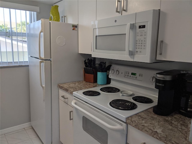 2373 N Beach Rd Unit 1C, Englewood, FL 34223 - kitchen with white appliances, white cabinetry, and light countertops