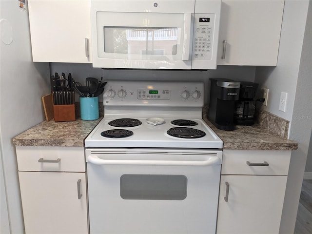 2373 N Beach Rd Unit 1C, Englewood, FL 34223 - kitchen with white appliances, white cabinetry, and light countertops