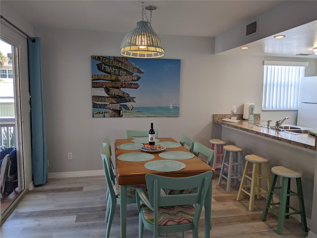 2373 N Beach Rd Unit 1C, Englewood, FL 34223 - dining space with light wood-style floors, plenty of natural light, and recessed lighting
