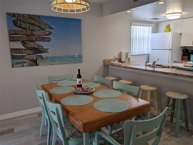 2373 N Beach Rd Unit 1C, Englewood, FL 34223 - dining space featuring light wood finished floors and baseboards