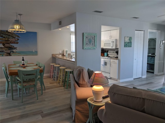 2373 N Beach Rd Unit 1C, Englewood, FL 34223 - living area featuring light wood-style floors and baseboards