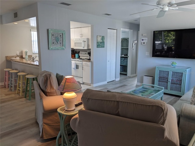 2373 N Beach Rd Unit 1C, Englewood, FL 34223 - living area with light wood-type flooring and ceiling fan