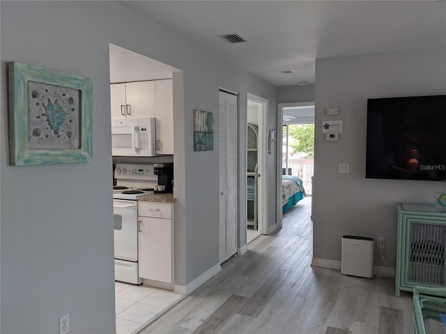 2373 N Beach Rd Unit 1C, Englewood, FL 34223 - hall featuring light wood-style floors and baseboards