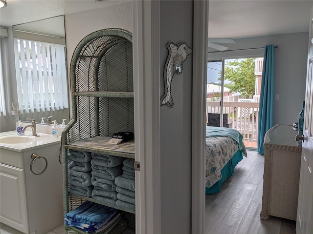 2373 N Beach Rd Unit 1C, Englewood, FL 34223 - bathroom with vanity, wood finished floors, ensuite bathroom, and a ceiling fan
