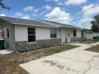 11216 Kimberly Ave Unit A & B, Englewood, FL 34224 - ranch-style home with stucco siding and stone siding