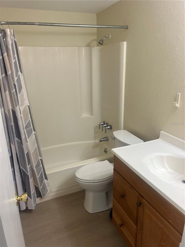 11216 Kimberly Ave Unit A & B, Englewood, FL 34224 - bathroom featuring wood finished floors, vanity, shower / bath combo with shower curtain, and a textured wall