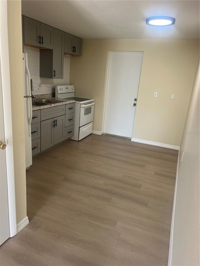 11216 Kimberly Ave Unit A & B, Englewood, FL 34224 - kitchen featuring white appliances, gray cabinets, light wood finished floors, and light countertops