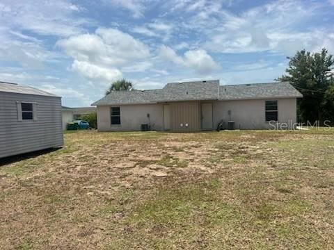 11216 Kimberly Ave Unit A & B, Englewood, FL 34224 - rear view of house featuring a yard