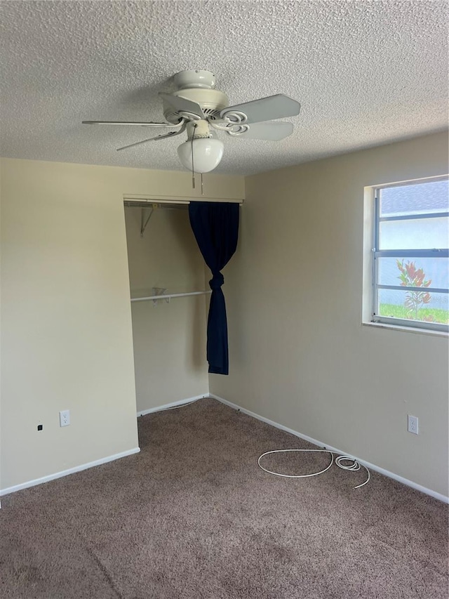 11216 Kimberly Ave Unit A & B, Englewood, FL 34224 - unfurnished bedroom with a textured ceiling, carpet floors, a closet, and ceiling fan