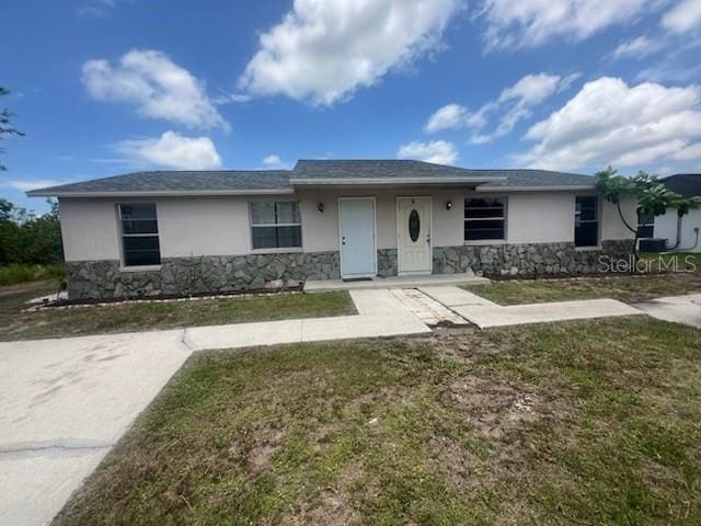 11216 Kimberly Ave Unit A & B, Englewood, FL 34224 - single story home with stucco siding, stone siding, and a front lawn