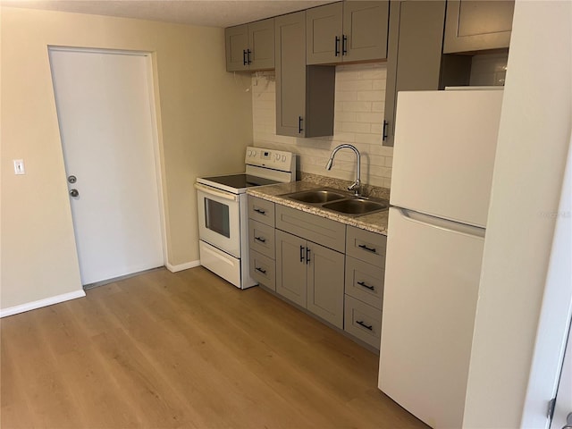11216 Kimberly Ave Unit A & B, Englewood, FL 34224 - kitchen featuring white appliances, gray cabinetry, backsplash, light wood finished floors, and light countertops