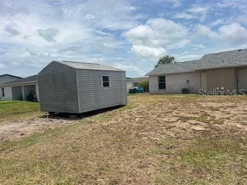 11216 Kimberly Ave Unit A & B, Englewood, FL 34224 - view of green lawn featuring a storage shed