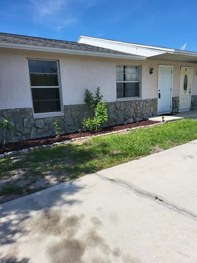 11216 Kimberly Ave Unit A & B, Englewood, FL 34224 - view of front of property featuring stone siding and stucco siding