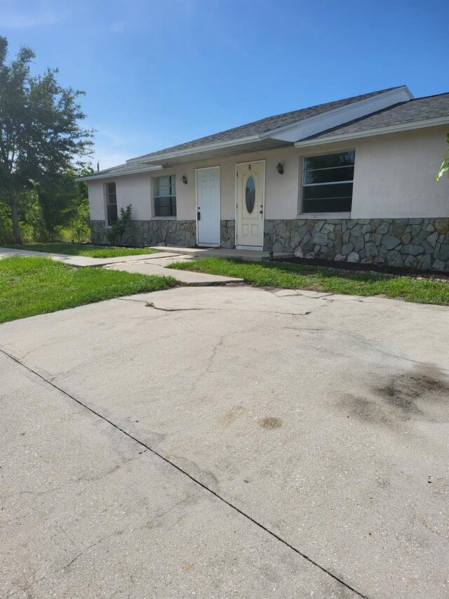 11216 Kimberly Ave Unit A & B, Englewood, FL 34224 - view of front of property featuring stucco siding and stone siding