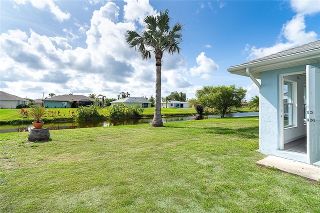 15 Bunker Pl, Rotonda West, FL 33947 - view of green lawn with a water view and a residential view