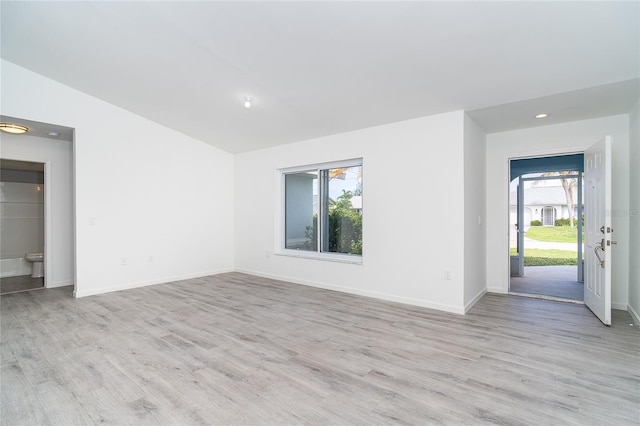 15 Bunker Pl, Rotonda West, FL 33947 - unfurnished living room with light wood-type flooring, lofted ceiling, and recessed lighting
