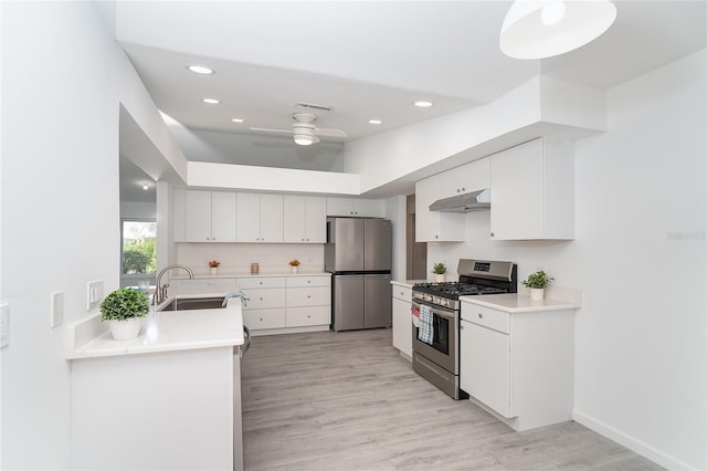 15 Bunker Pl, Rotonda West, FL 33947 - kitchen featuring stainless steel appliances, under cabinet range hood, a ceiling fan, white cabinetry, and recessed lighting