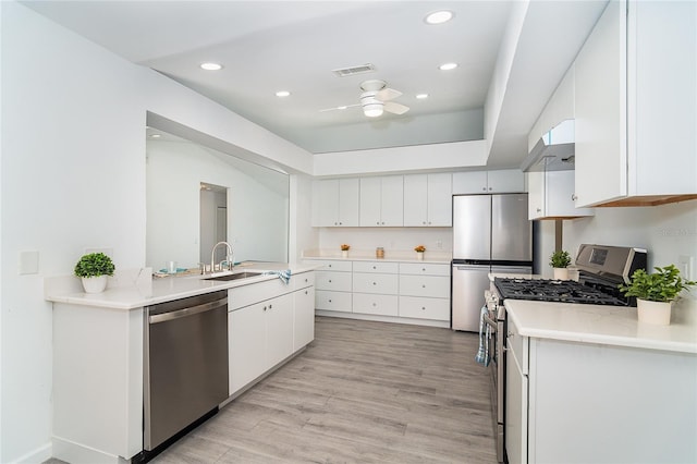 15 Bunker Pl, Rotonda West, FL 33947 - kitchen with appliances with stainless steel finishes, a ceiling fan, white cabinetry, recessed lighting, and light wood finished floors