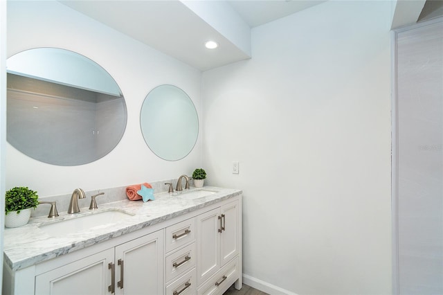 15 Bunker Pl, Rotonda West, FL 33947 - bathroom featuring double vanity and recessed lighting