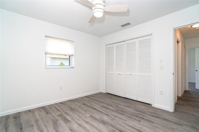 15 Bunker Pl, Rotonda West, FL 33947 - unfurnished bedroom with wood finished floors, a closet, and ceiling fan