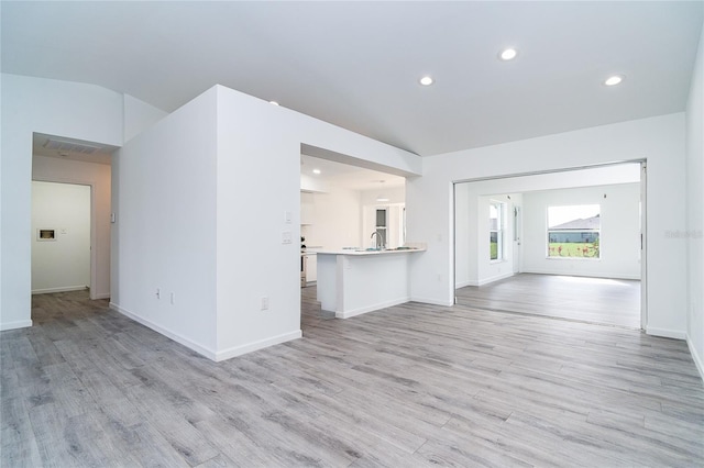 15 Bunker Pl, Rotonda West, FL 33947 - unfurnished living room featuring light wood-type flooring and recessed lighting