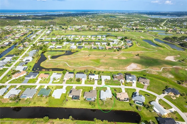 15 Bunker Pl, Rotonda West, FL 33947 - aerial view of property and surrounding area featuring nearby suburban area, a large body of water, and a local golf course