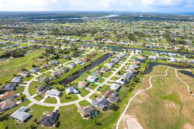 15 Bunker Pl, Rotonda West, FL 33947 - aerial view of property and surrounding area with nearby suburban area, a large body of water, and a golf course