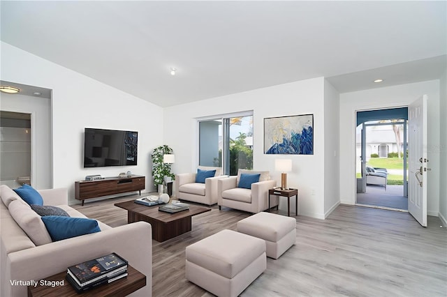15 Bunker Pl, Rotonda West, FL 33947 - living room with light wood-type flooring, vaulted ceiling, and recessed lighting
