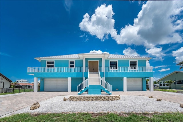 1930 Massachusetts Ave, Englewood, FL 34224 - beach home with an attached garage, stairs, decorative driveway, and a standing seam roof