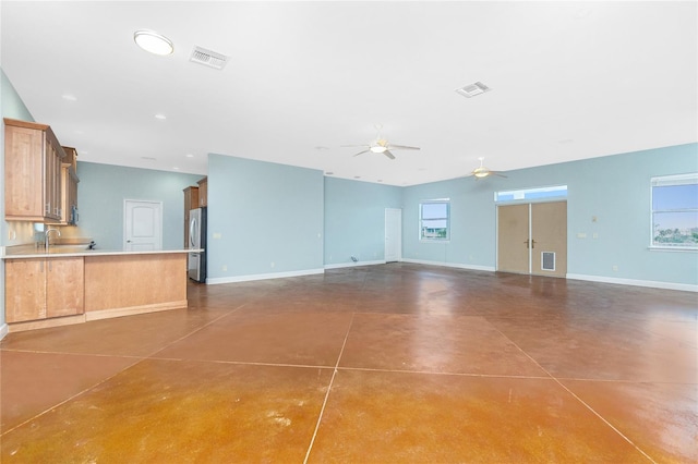 1930 Massachusetts Ave, Englewood, FL 34224 - unfurnished living room with a ceiling fan and finished concrete flooring